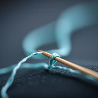 Needle close-up with cotton thread