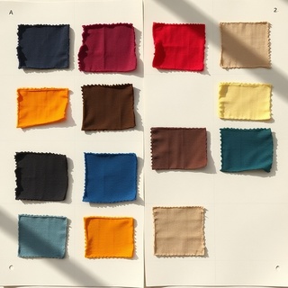 Array of natural dye fabric samples pinned on board